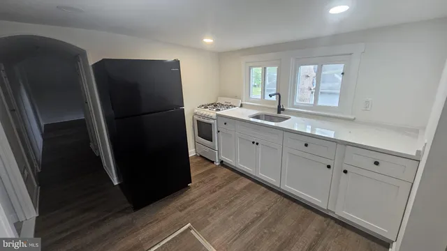 a kitchen with refrigerator and window