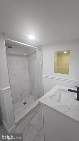 a bathroom with a shower and mirror