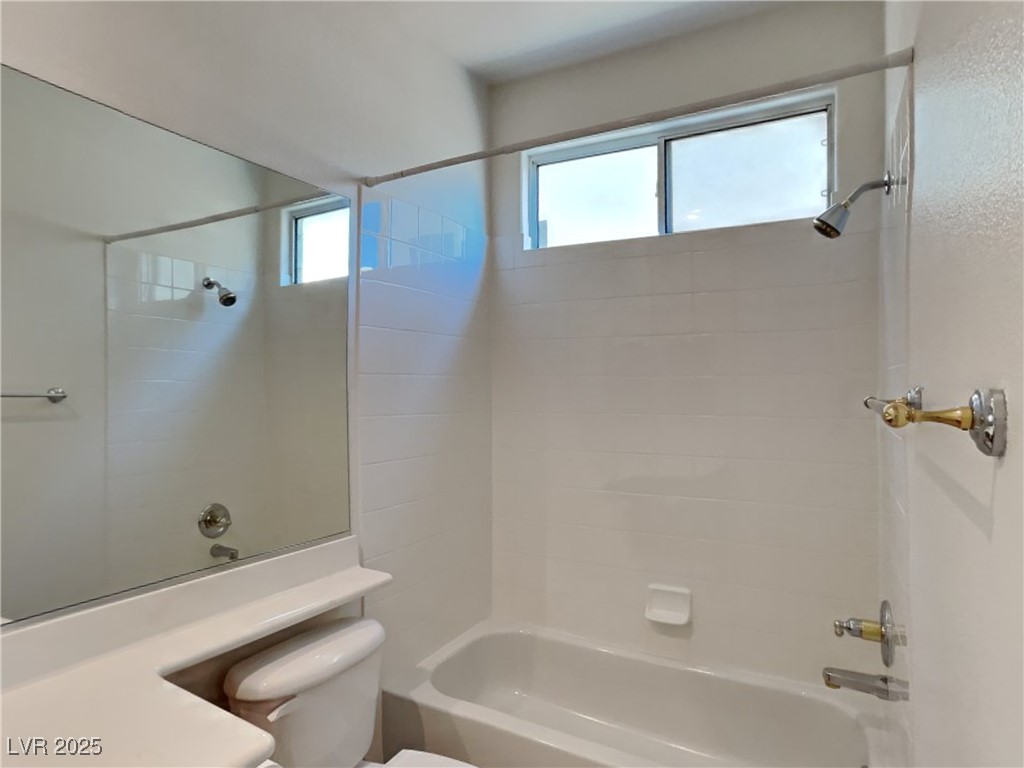 9456 Bluff Ledge Avenue Las Vegas, NV 89149 - Photo 15 of 35 Full bath featuring shower / tub combination, plenty of natural light, and vanity