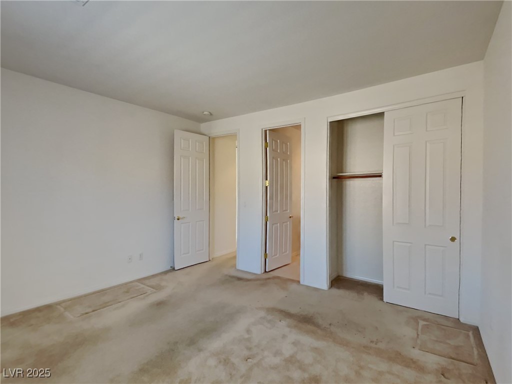 9456 Bluff Ledge Avenue Las Vegas, NV 89149 - Photo 17 of 35 Unfurnished bedroom featuring carpet floors and a closet