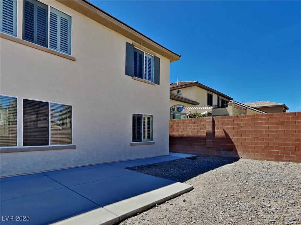 9456 Bluff Ledge Avenue Las Vegas, NV 89149 - Photo 35 of 35 View of property exterior featuring stucco siding and a patio