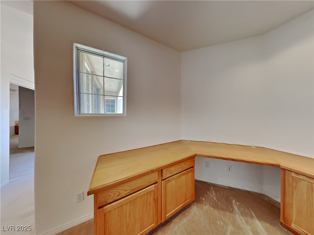 9456 Bluff Ledge Avenue Las Vegas, NV 89149 - Photo 9 of 35 Unfurnished office featuring built in desk and light colored carpet