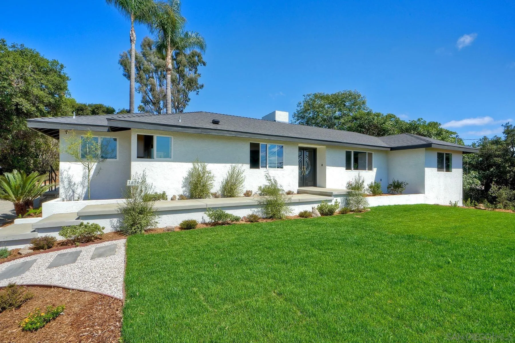 a front view of house with yard and outdoor seating