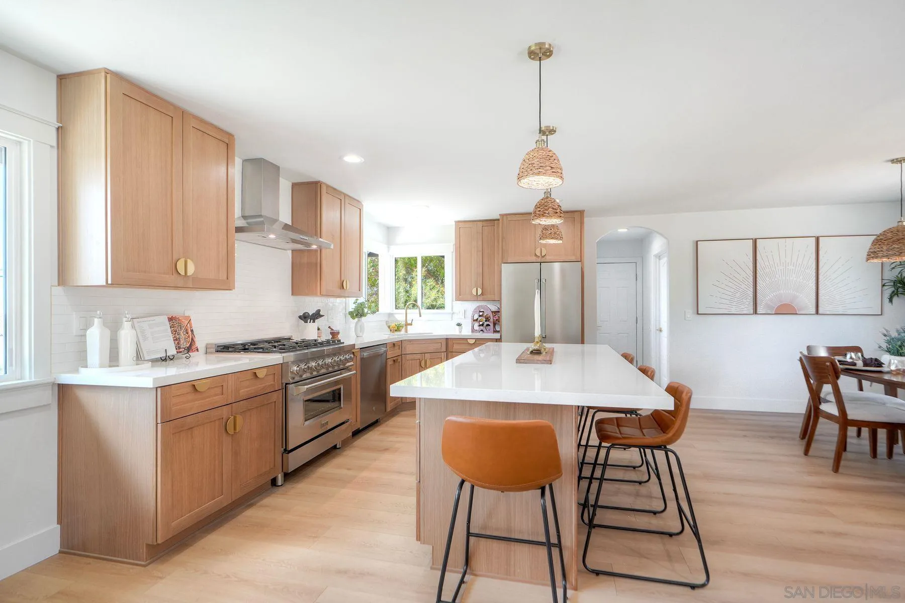 1870 Laurel Road Oceanside, CA 92054 - Photo 13 of 57 a kitchen with stainless steel appliances granite countertop a stove a sink dishwasher a stove a refrigerator with a dining table and chairs