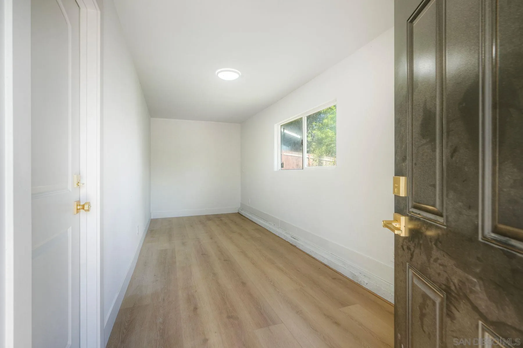 1870 Laurel Road Oceanside, CA 92054 - Photo 37 of 57 a view of a room with wooden floor and a window
