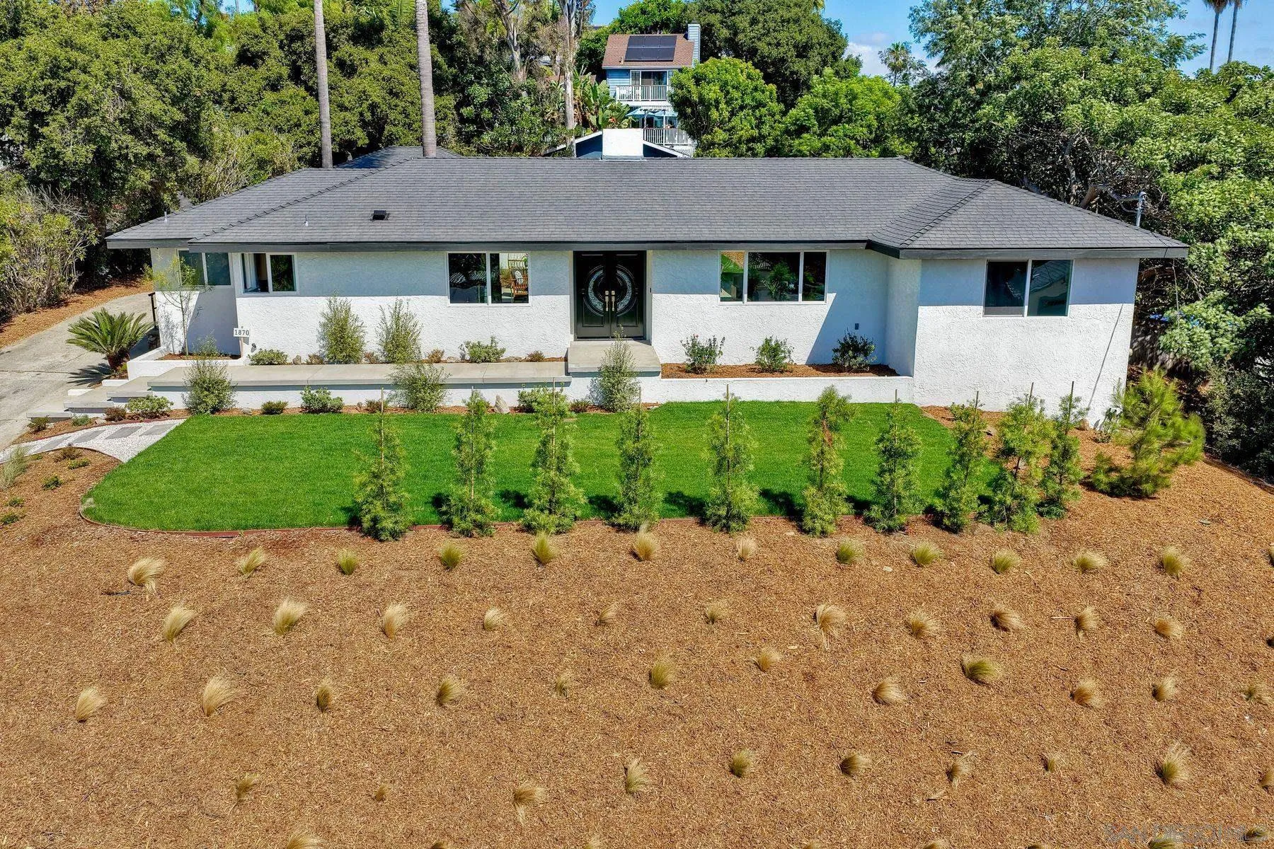 1870 Laurel Road Oceanside, CA 92054 - Photo 48 of 57 a front view of a house with a garden and yard