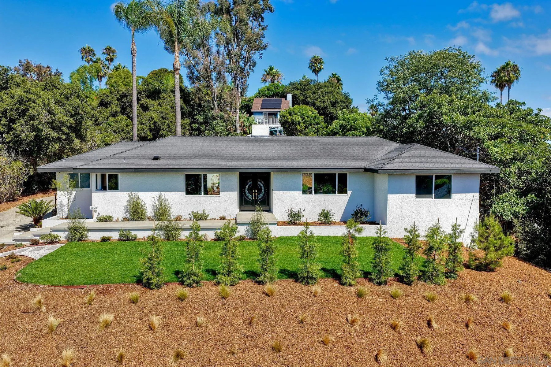 1870 Laurel Road Oceanside, CA 92054 - Photo 55 of 57 a front view of a house with a yard and porch