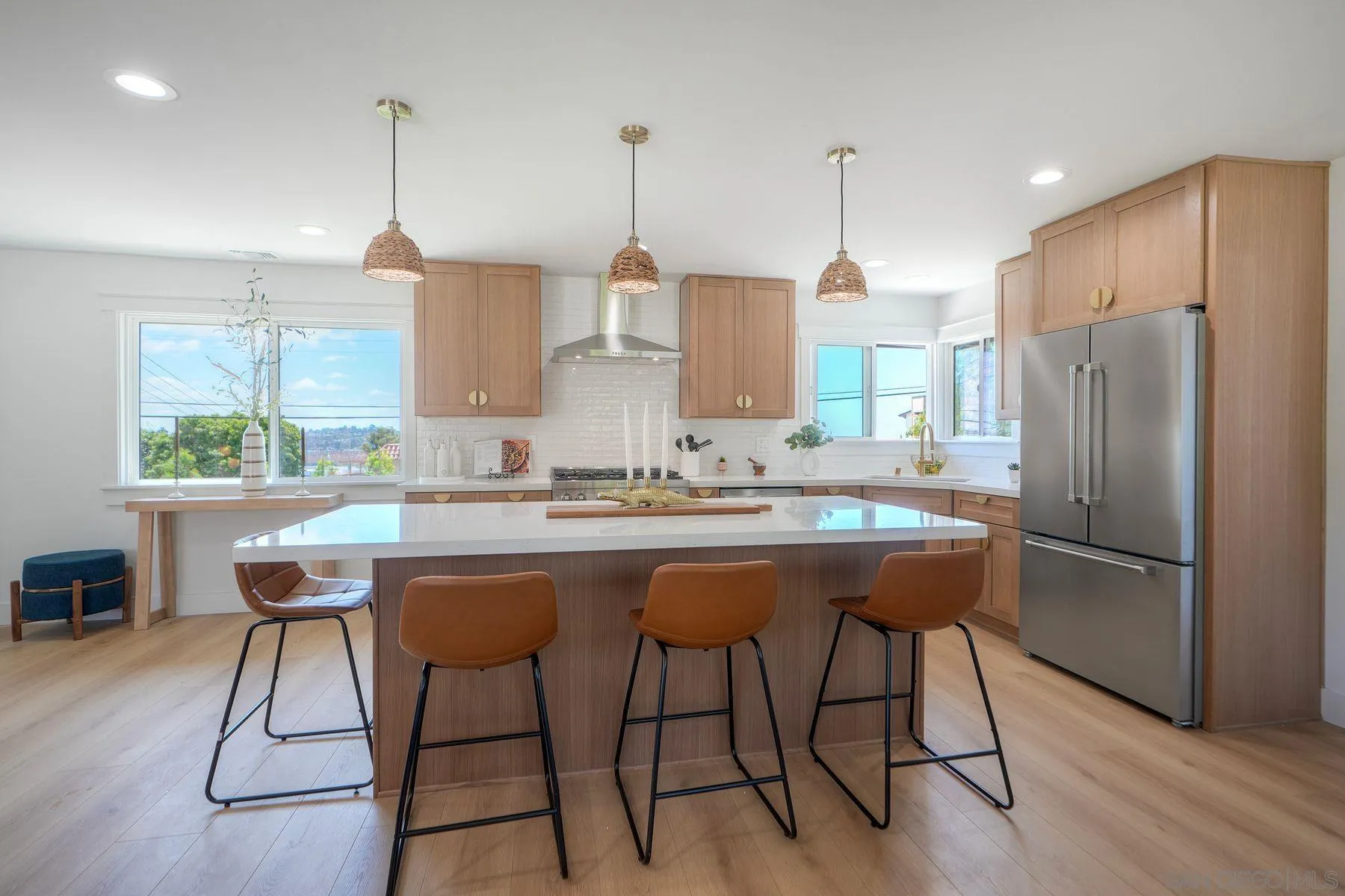 1870 Laurel Road Oceanside, CA 92054 - Photo 9 of 57 a kitchen with stainless steel appliances granite countertop a sink a stove a refrigerator and island with wooden floor