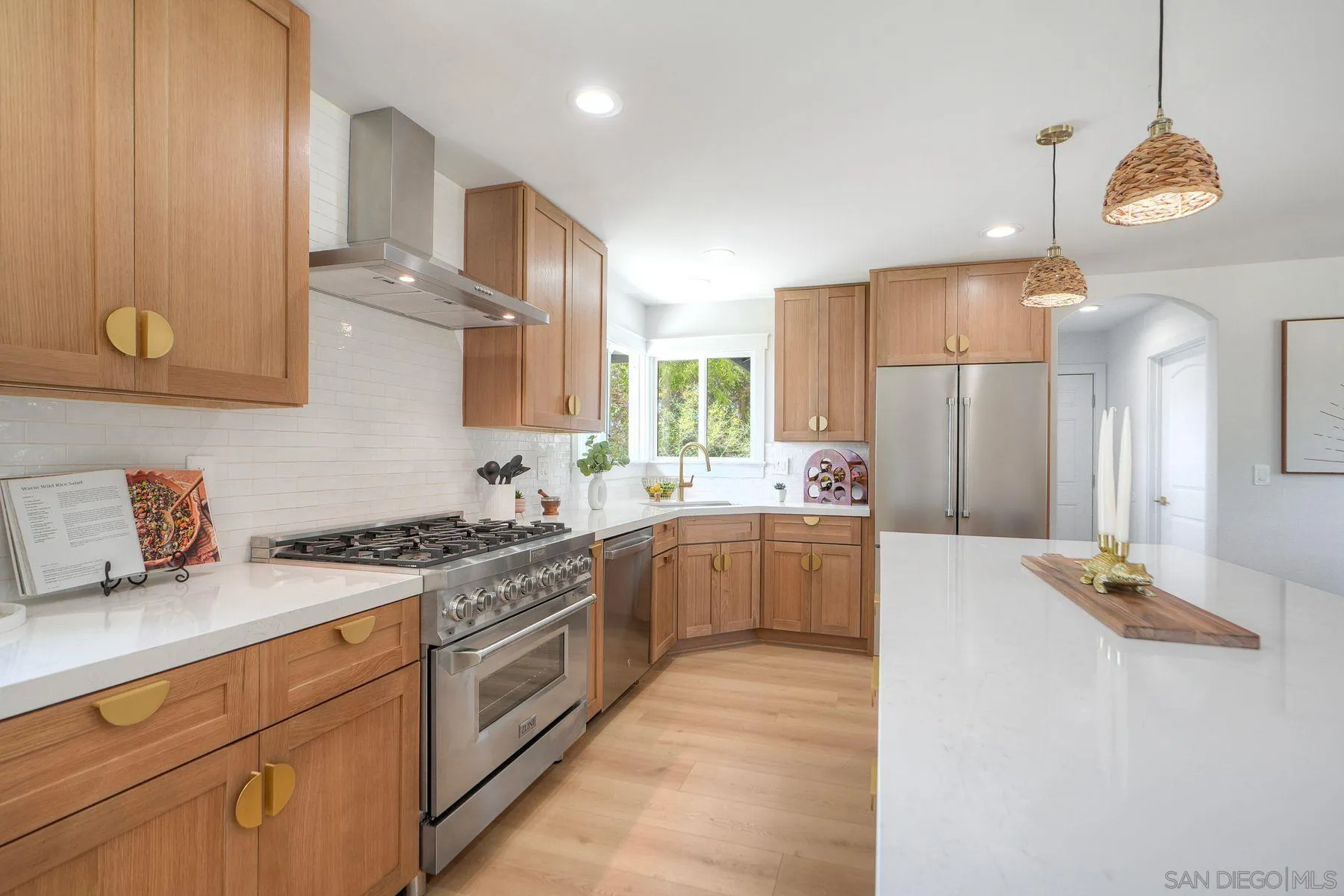 1870 Laurel Road Oceanside, CA 92054 - Photo 10 of 57 a kitchen with stainless steel appliances granite countertop a sink a stove and a refrigerator