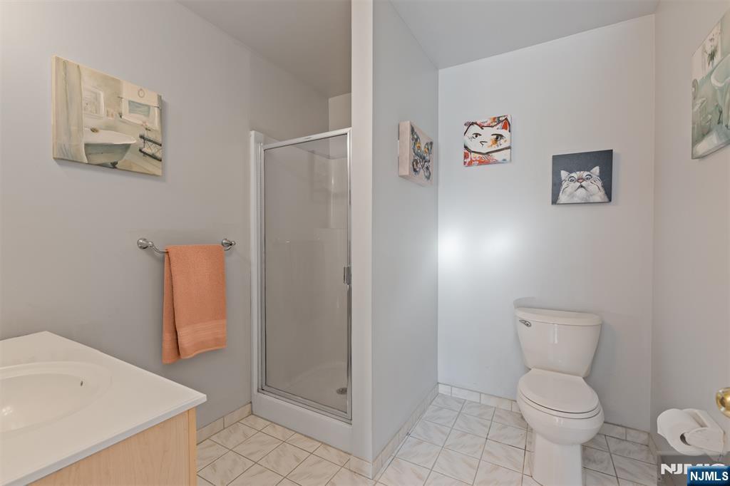 11 Parkside Court Wayne, NJ 07470 - Photo 16 of 22 a bathroom with a toilet and a shower