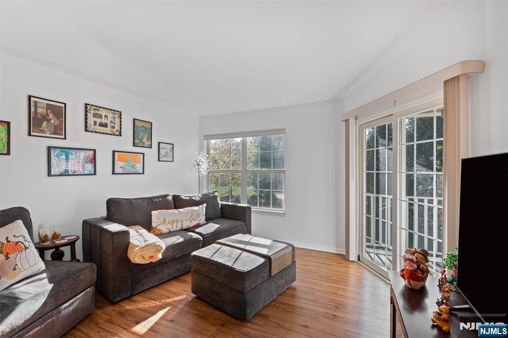 11 Parkside Court Wayne, NJ 07470 - Photo 2 of 22 a living room with furniture flat screen tv and a window