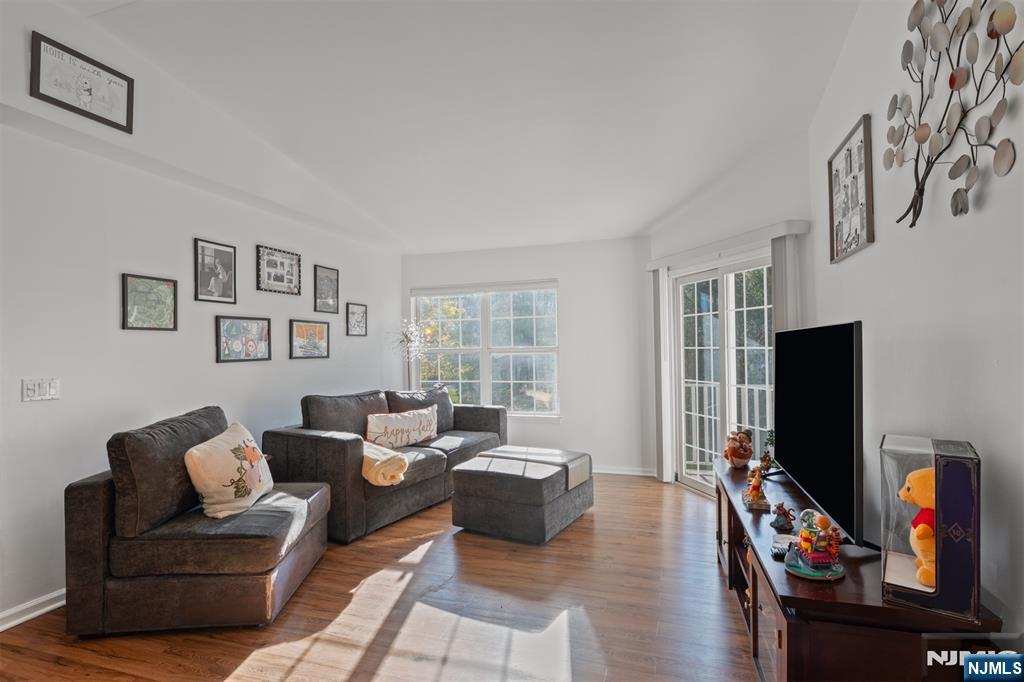 11 Parkside Court Wayne, NJ 07470 - Photo 3 of 22 a living room with furniture a flat screen tv and a window