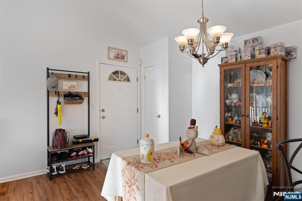 11 Parkside Court Wayne, NJ 07470 - Photo 8 of 22 a view of a dining room with furniture a chandelier and wooden floor