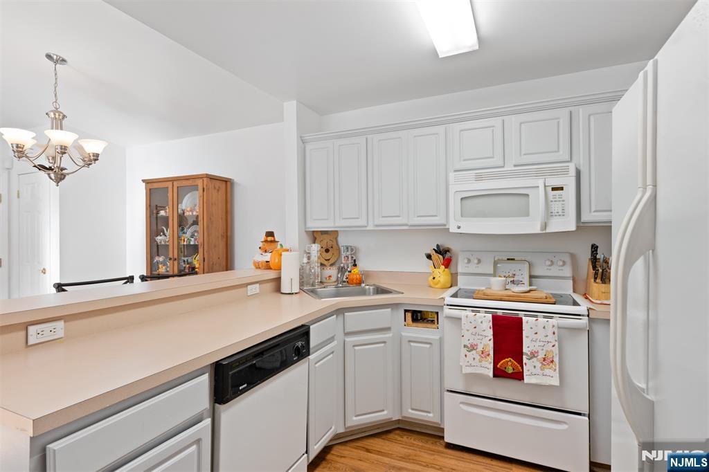 11 Parkside Court Wayne, NJ 07470 - Photo 9 of 22 a kitchen with stainless steel appliances a sink stove and cabinets