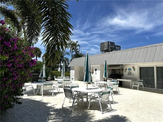 a view of a patio with a table and chairs