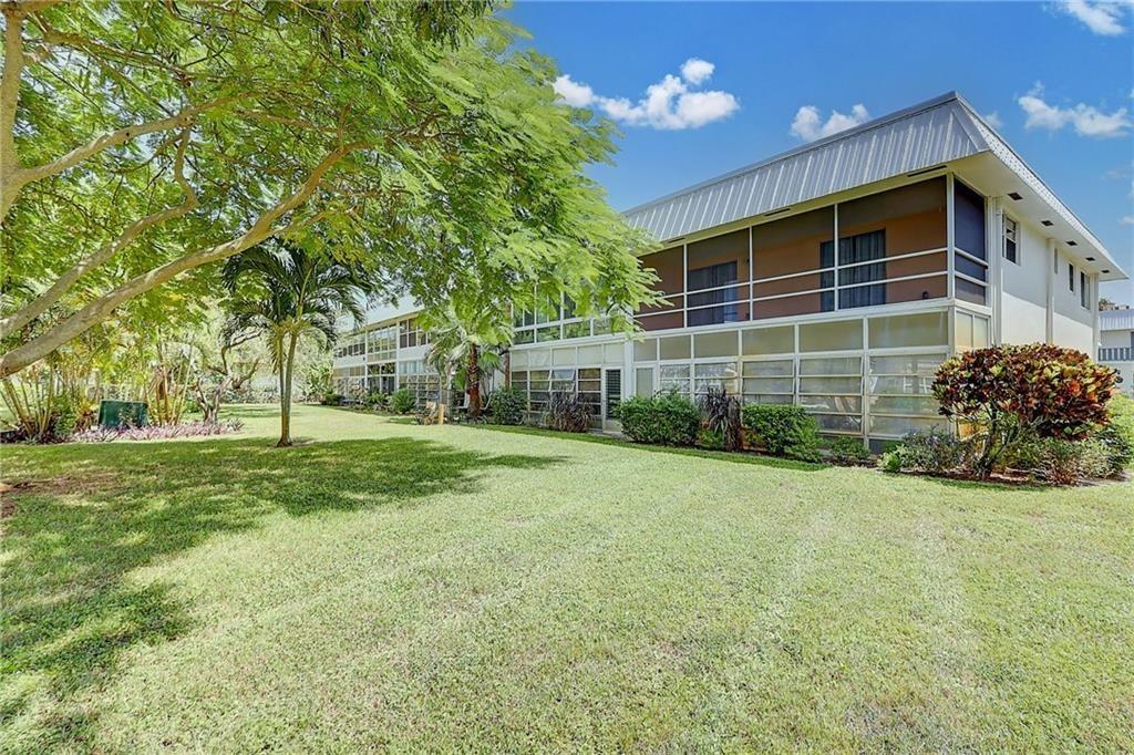 2929 Southeast Ocean Boulevard, Unit 1423 Stuart, FL 34996 - Photo 13 of 16 a view of a house with backyard and trees
