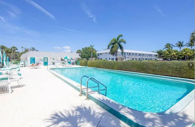 a view of a swimming pool with a yard