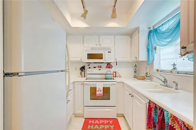 a kitchen with a sink a stove and a refrigerator