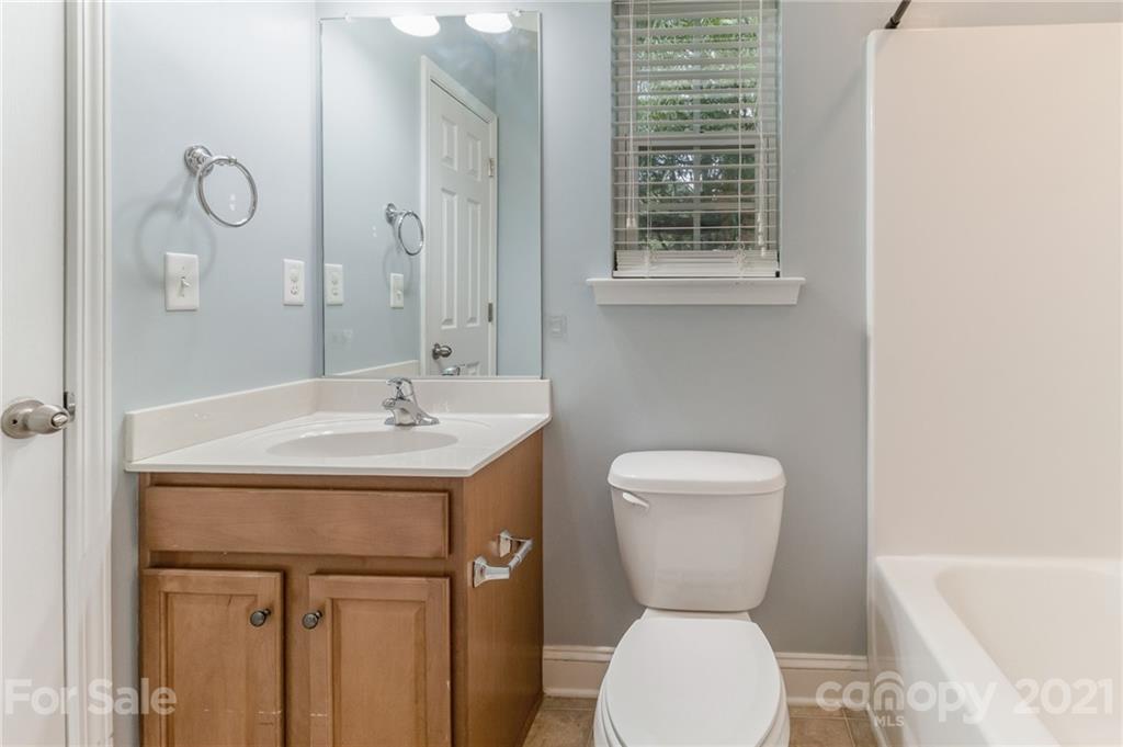 101 Old Meadowbrook Road Mooresville, NC 28115 - Photo 17 of 18 a bathroom with a toilet sink and mirror