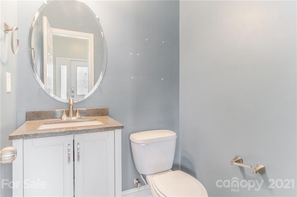 101 Old Meadowbrook Road Mooresville, NC 28115 - Photo 18 of 18 a bathroom with a toilet a sink and a mirror