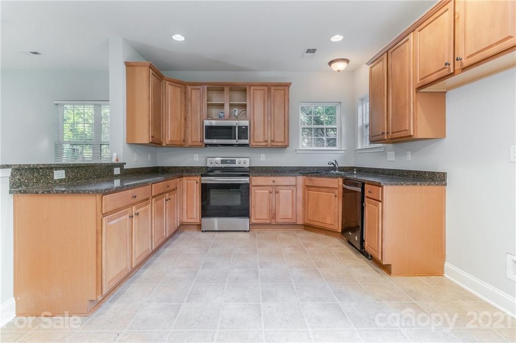101 Old Meadowbrook Road Mooresville, NC 28115 - Photo 2 of 18 a kitchen with stainless steel appliances granite countertop a stove sink and cabinets