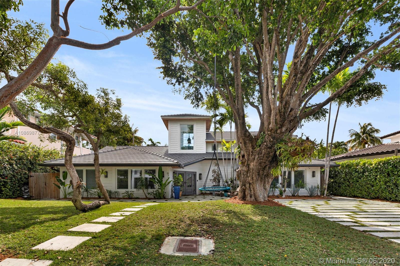 677 Ridgewood Road Key Biscayne, FL 33149 - Photo 1 of 38 front view of a house with a yard