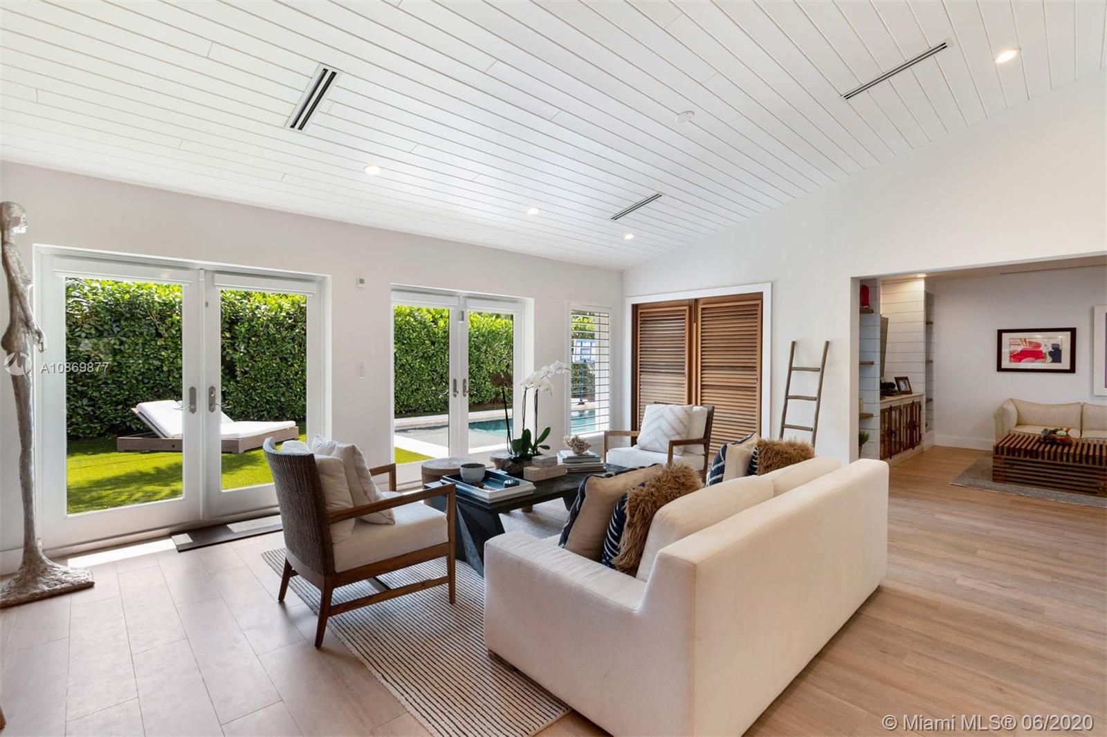 677 Ridgewood Road Key Biscayne, FL 33149 - Photo 12 of 38 a living room with furniture and a large window