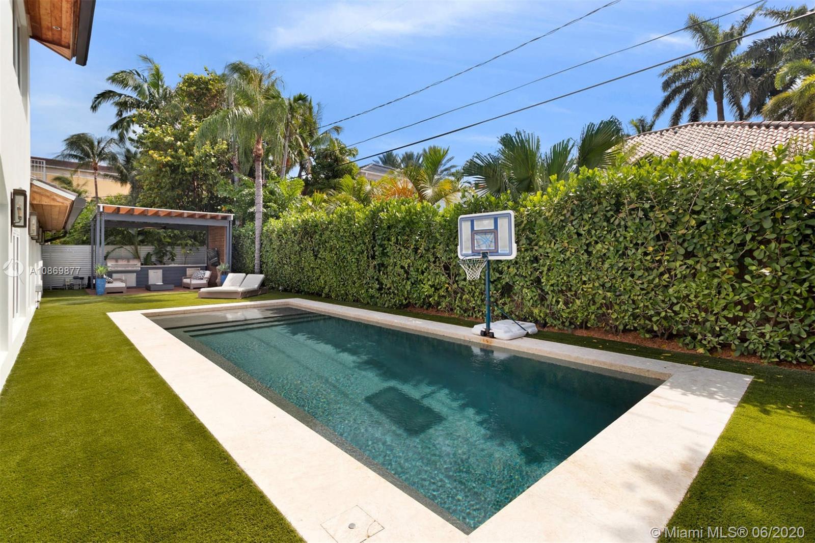 677 Ridgewood Road Key Biscayne, FL 33149 - Photo 13 of 38 a view of a swimming pool with a yard