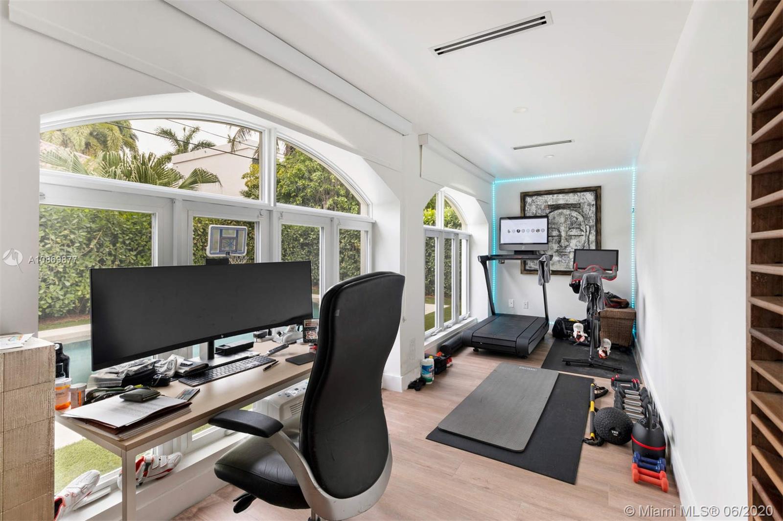 677 Ridgewood Road Key Biscayne, FL 33149 - Photo 15 of 38 a view of workspace with wooden floor windows gym equipment and windows
