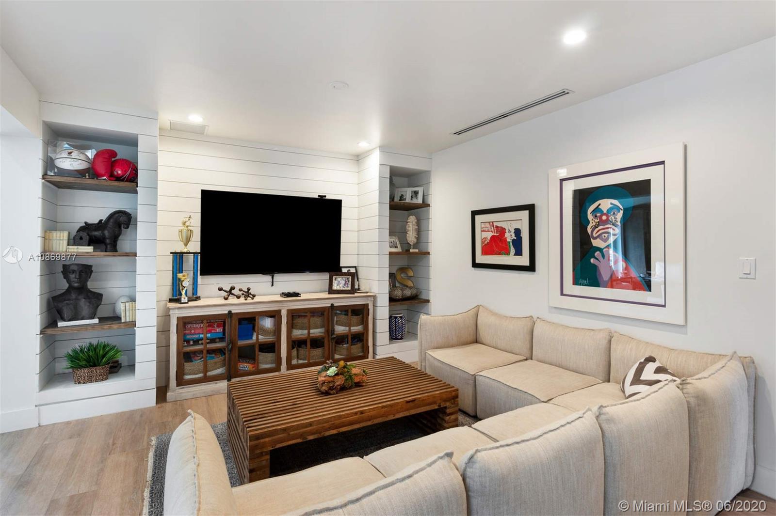 677 Ridgewood Road Key Biscayne, FL 33149 - Photo 16 of 38 a living room with furniture and a flat screen tv