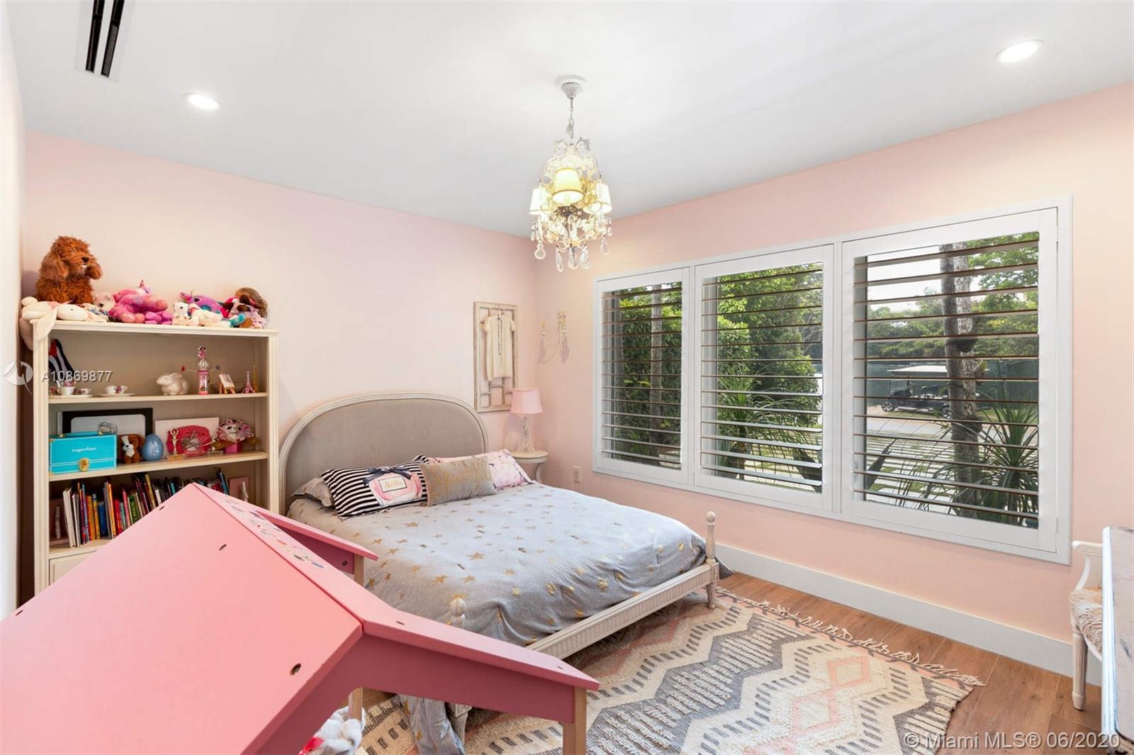 677 Ridgewood Road Key Biscayne, FL 33149 - Photo 20 of 38 a bedroom with a bed and a window