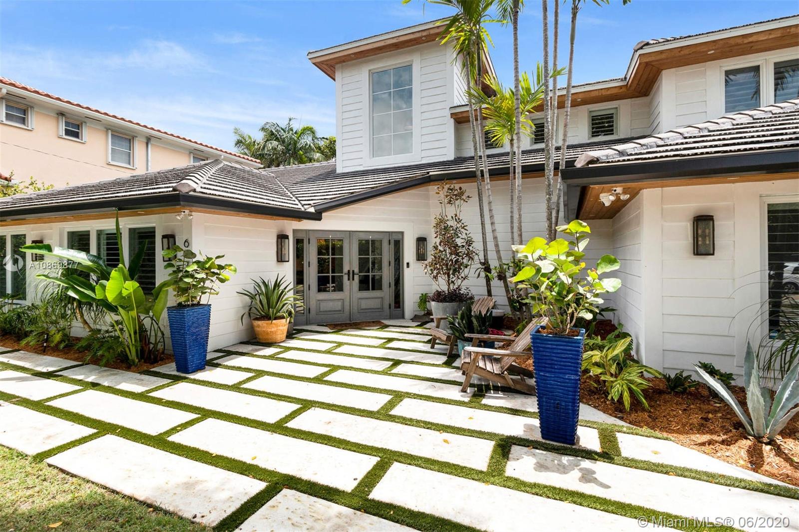 677 Ridgewood Road Key Biscayne, FL 33149 - Photo 2 of 38 a view of a house with a patio