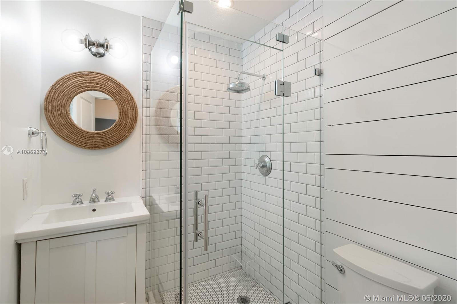 677 Ridgewood Road Key Biscayne, FL 33149 - Photo 23 of 38 a bathroom with a sink a toilet and shower