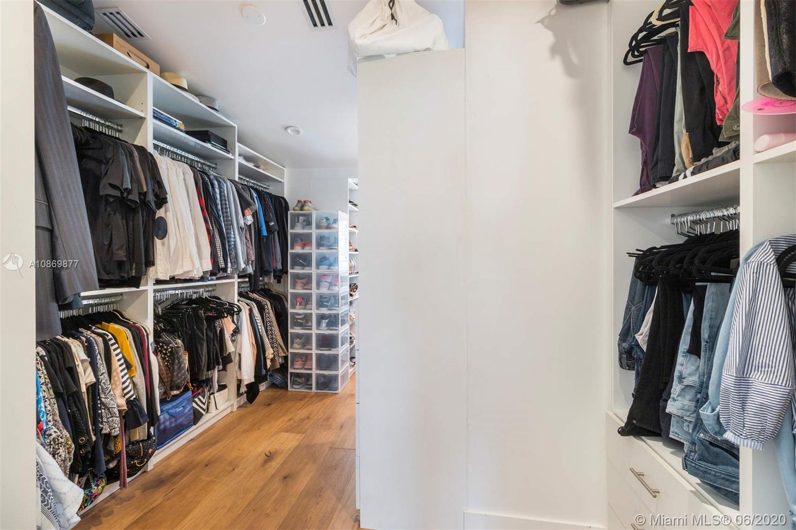 677 Ridgewood Road Key Biscayne, FL 33149 - Photo 28 of 38 a view of walk in closet with clothes and shoes