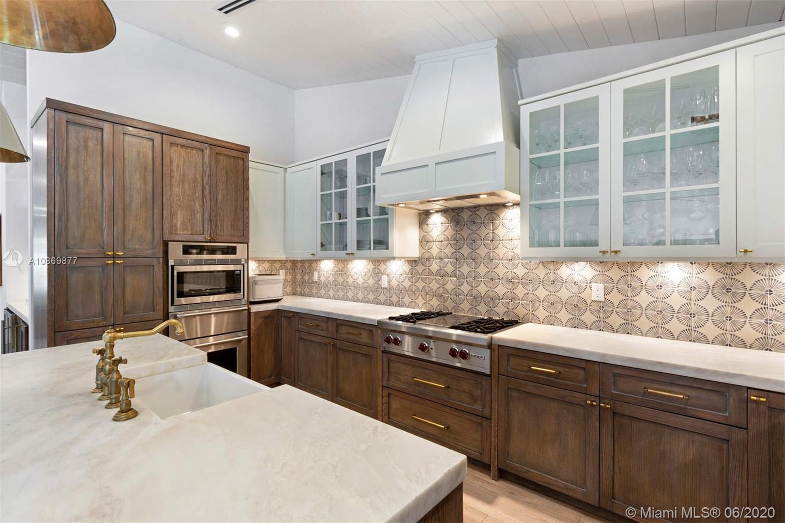 677 Ridgewood Road Key Biscayne, FL 33149 - Photo 6 of 38 a kitchen with a sink stove and refrigerator