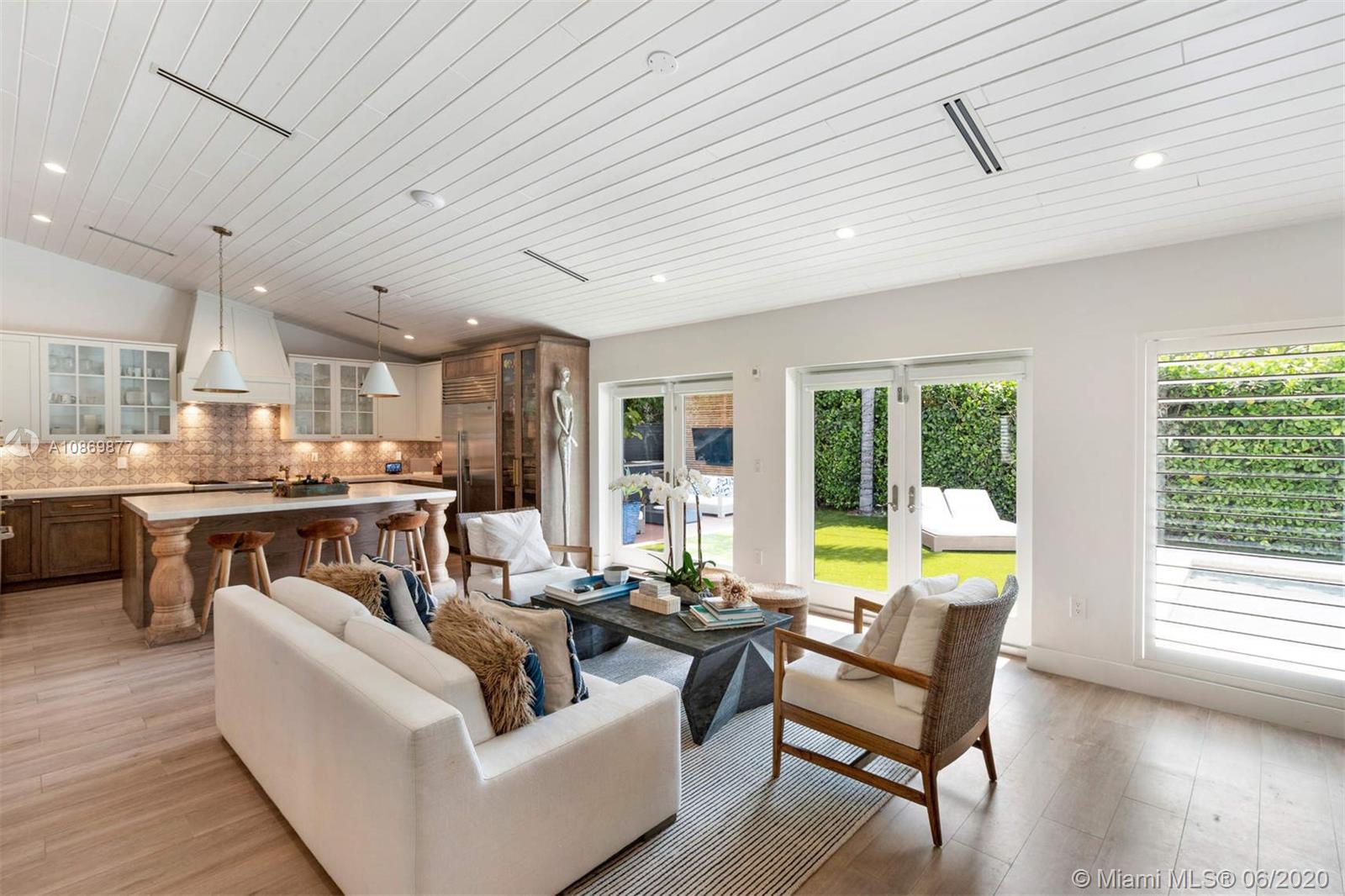 677 Ridgewood Road Key Biscayne, FL 33149 - Photo 9 of 38 a living room with furniture and a table