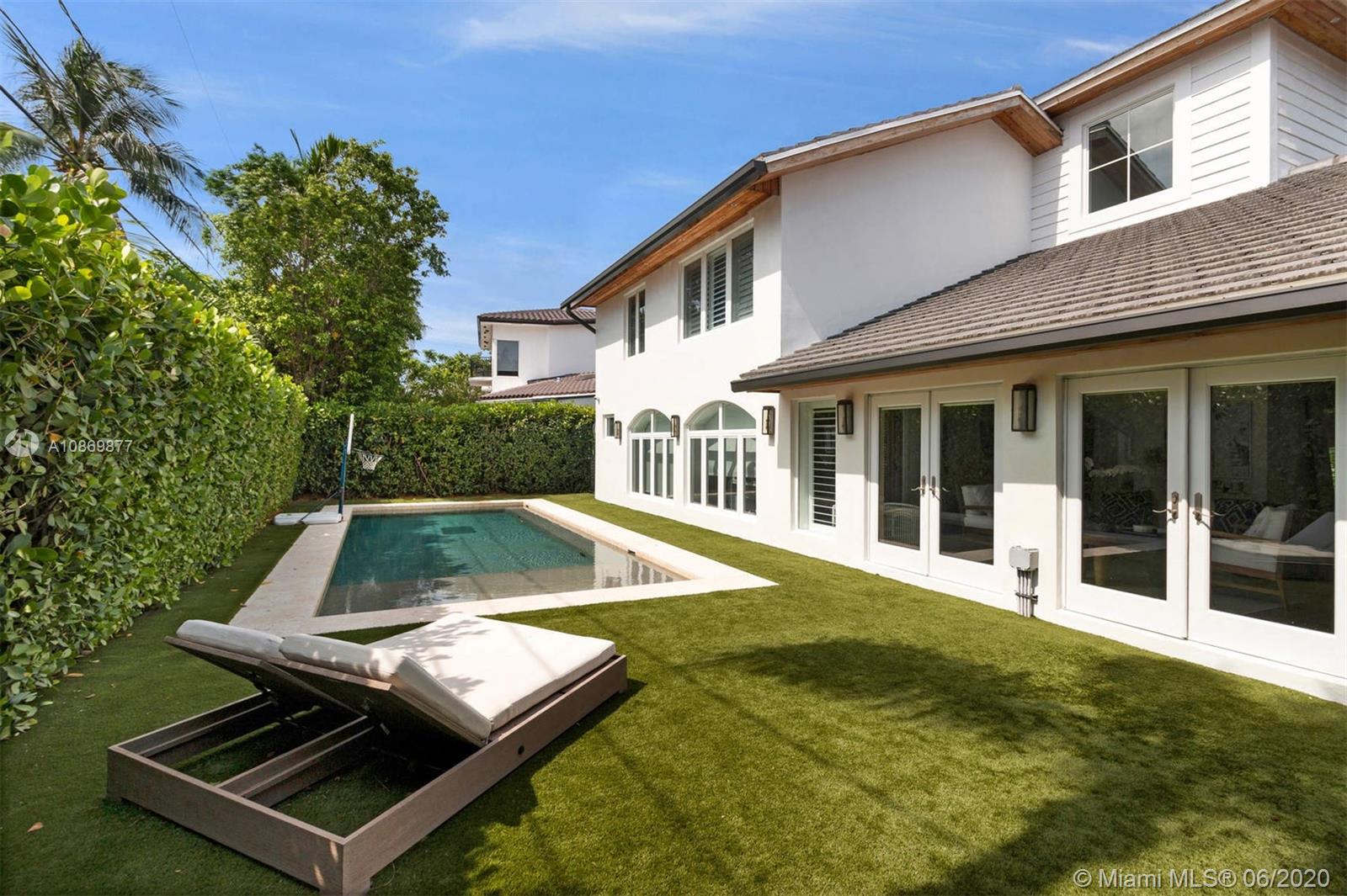 677 Ridgewood Road Key Biscayne, FL 33149 - Photo 10 of 38 front view of a house with a yard