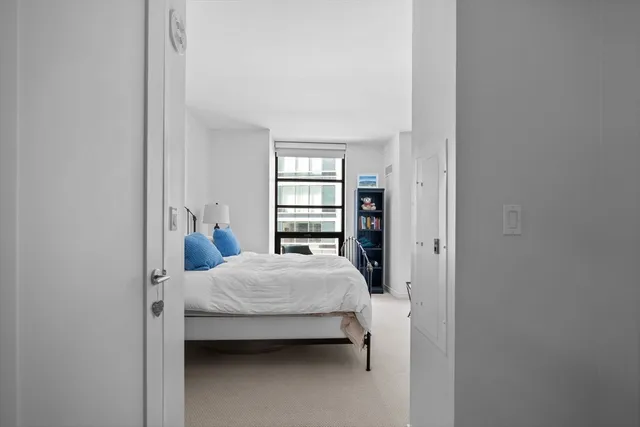 a bedroom with a bed and a window