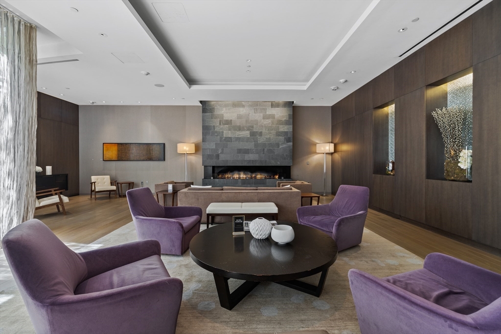 580 Washington Street, Unit 411 Boston, MA 02111 - Photo 21 of 24 a living room with furniture and a flat screen tv