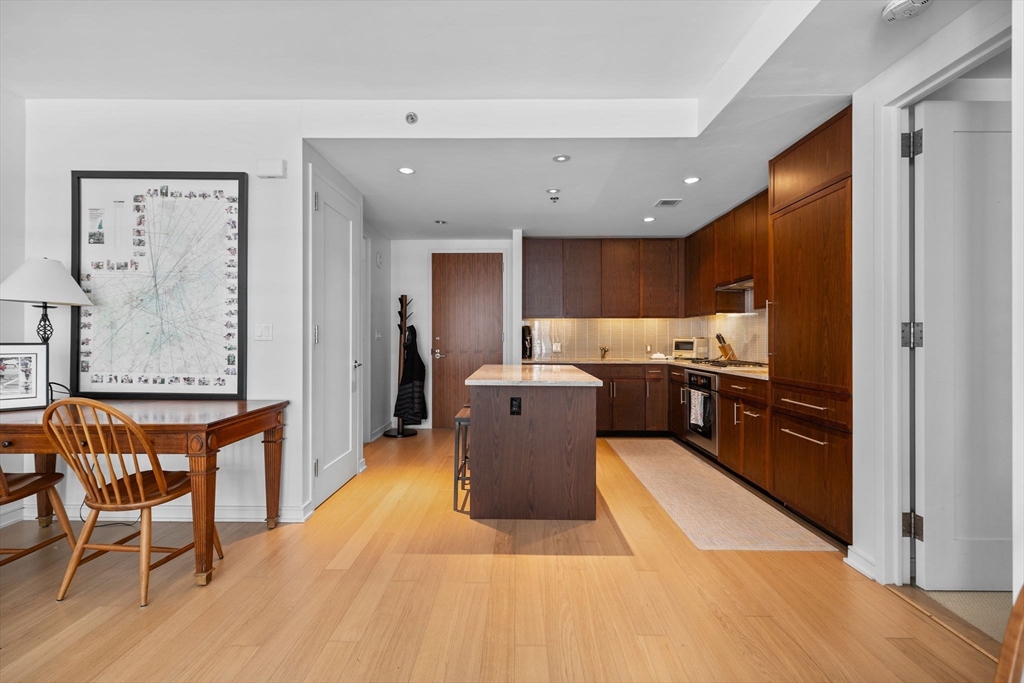 580 Washington Street, Unit 411 Boston, MA 02111 - Photo 4 of 24 a large kitchen with a table and chairs
