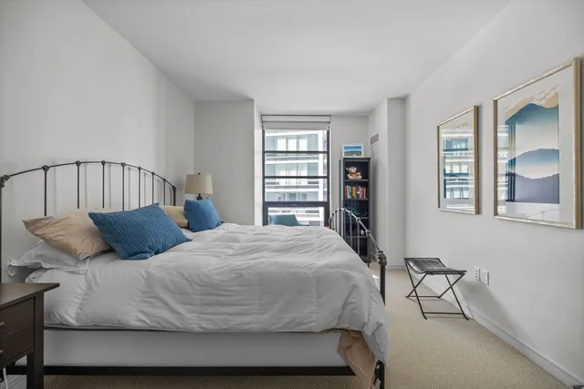 a bedroom with a large bed and a closet