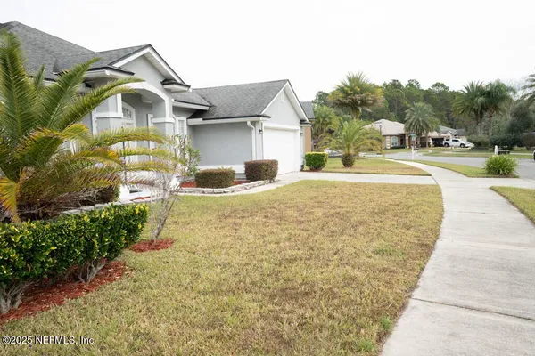 a big house with a big yard and large trees
