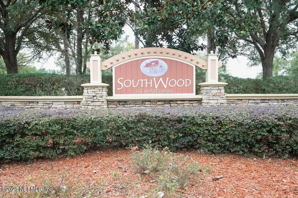 a view of outdoor space with sign board and trees