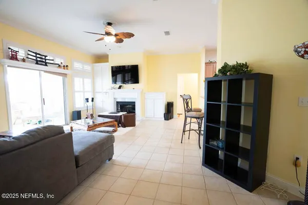 a kitchen with stainless steel appliances granite countertop a sink a stove a refrigerator a washer dryer and a dining table