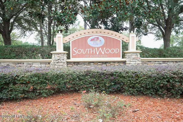 a view of outdoor space with sign board and trees