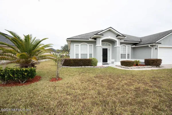 a front view of a house with a yard and garage