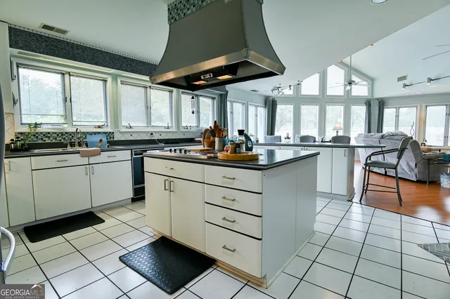a kitchen with a sink a stove a refrigerator and cabinets