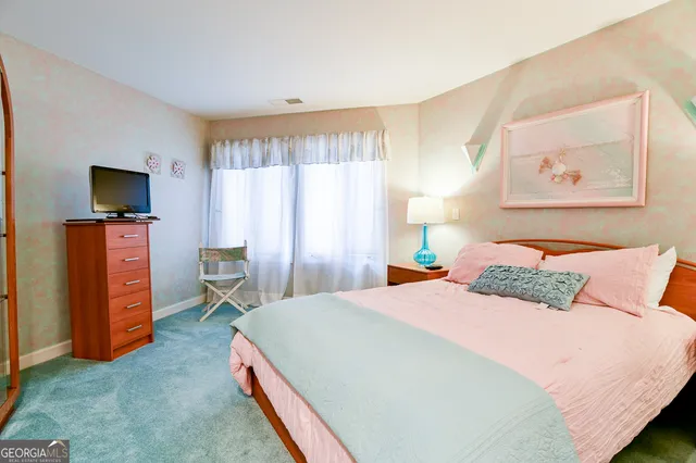 a bedroom with a bed and a television