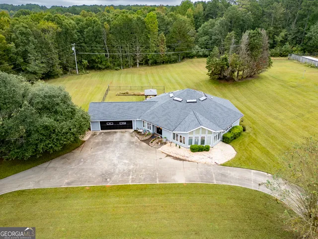 a view of a house with swimming pool and a yard