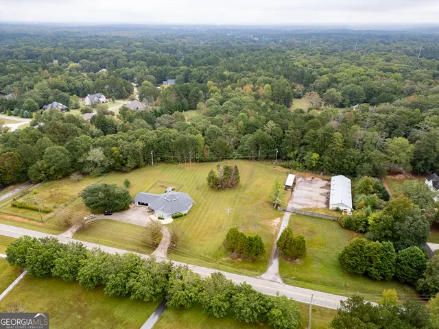 an aerial view of residential houses with outdoor space and swimming pool